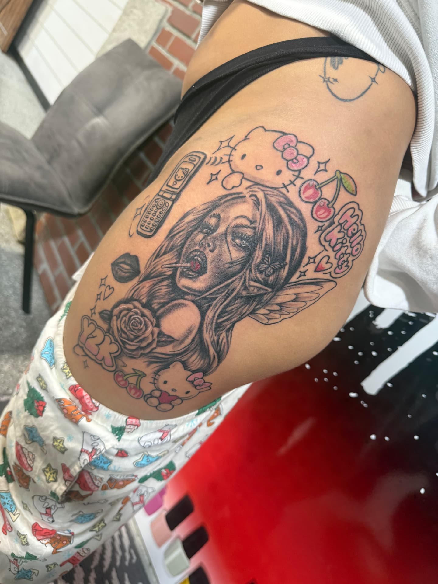 Y2K anime thigh tattoo with pink accents and cherries